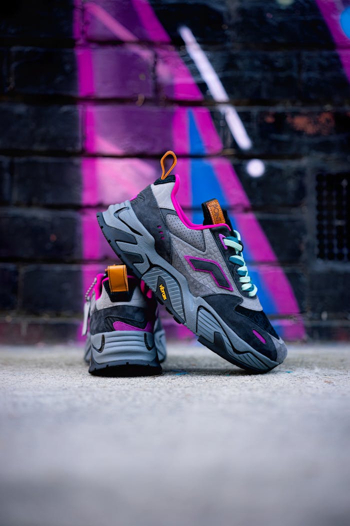 Trendy sport shoes displayed creatively with a dynamic neon graffiti background.